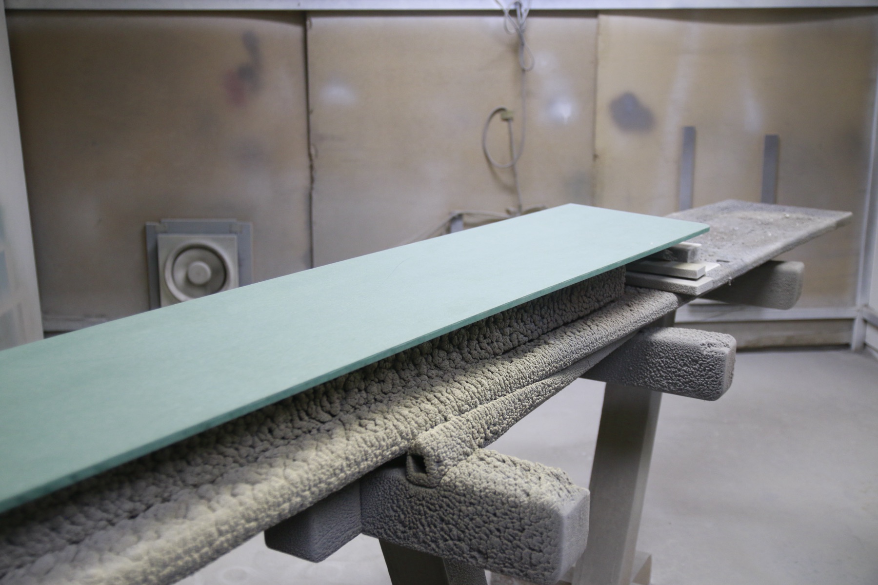 A freshly spray-painted panel drying in the finishing area